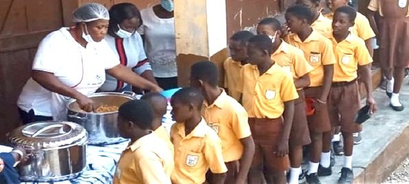 Krachi East school feeding programme cooks preparing meals for pupils in Ghana